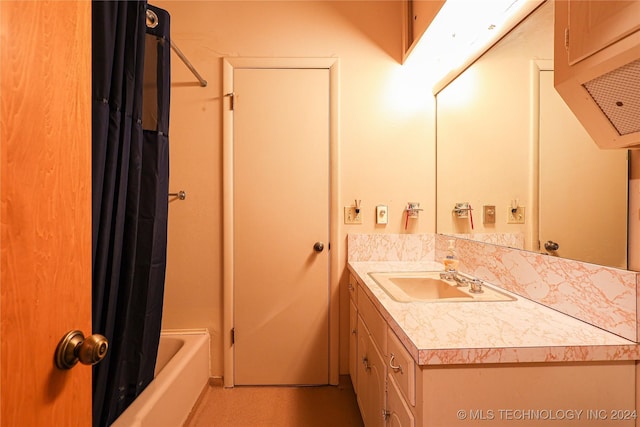 bathroom featuring vanity and shower / tub combo with curtain