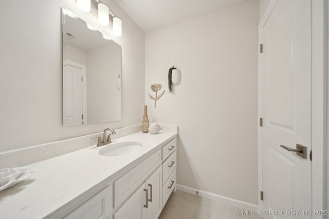 bathroom with tile patterned flooring, baseboards, and vanity