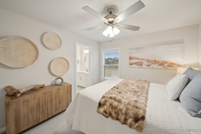 bedroom featuring ceiling fan, light carpet, and connected bathroom