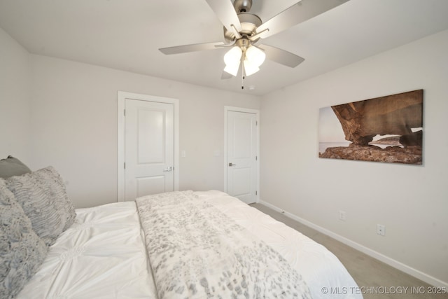 bedroom with a ceiling fan, carpet flooring, and baseboards