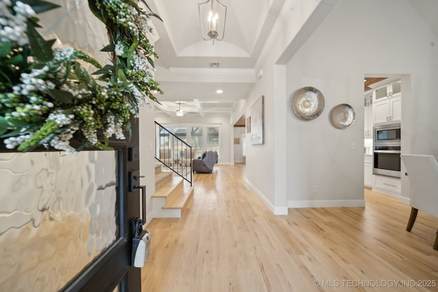 entrance foyer featuring stairs, visible vents, light wood-style flooring, and baseboards