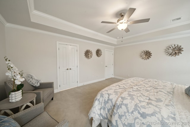 bedroom with light colored carpet, visible vents, baseboards, a raised ceiling, and crown molding