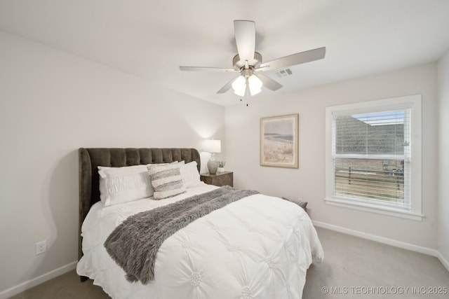 carpeted bedroom with a ceiling fan, visible vents, and baseboards