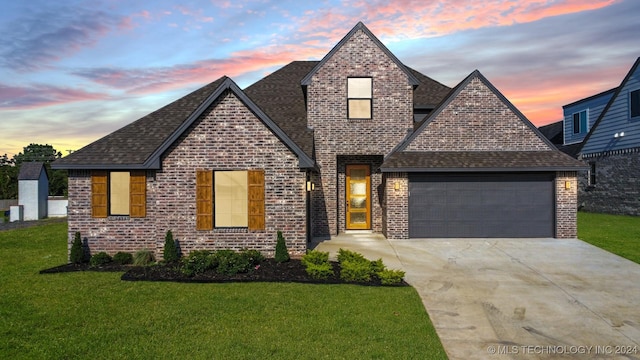 view of front facade featuring a lawn and a garage