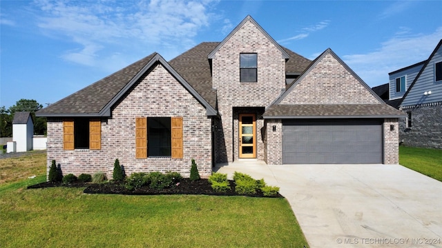 view of front of house with a garage and a front lawn