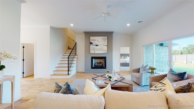 living room with ceiling fan and light wood-type flooring