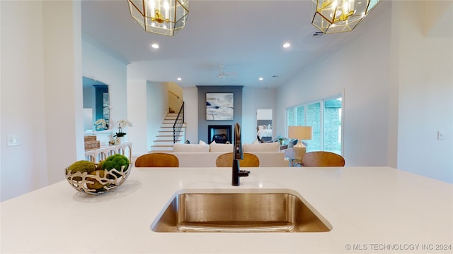 kitchen featuring sink, hanging light fixtures, and a notable chandelier