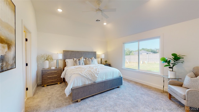 carpeted bedroom featuring ceiling fan and vaulted ceiling