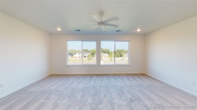 carpeted empty room featuring ceiling fan