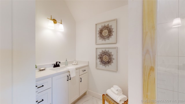 bathroom featuring vanity and vaulted ceiling