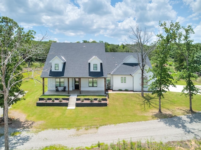 modern farmhouse featuring a front lawn and a porch