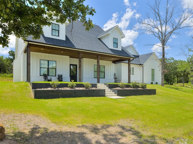 view of front of home featuring a front lawn and a porch