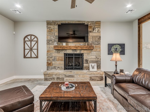 living room featuring a stone fireplace