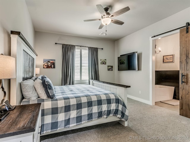 carpeted bedroom featuring a barn door and ceiling fan