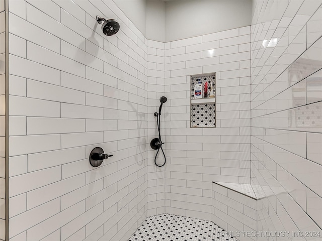 bathroom with a tile shower