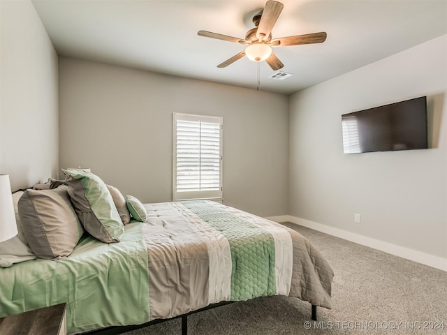 bedroom featuring ceiling fan and carpet