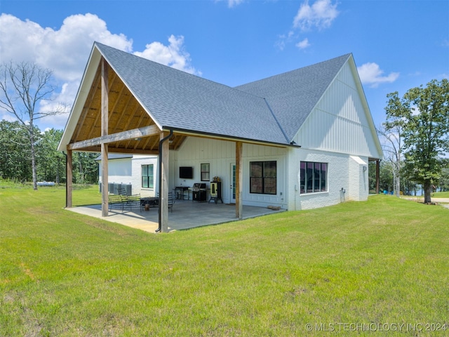 back of property featuring a lawn and a patio