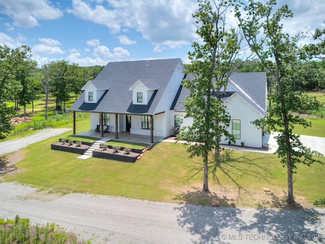 view of front of house with covered porch and a front yard