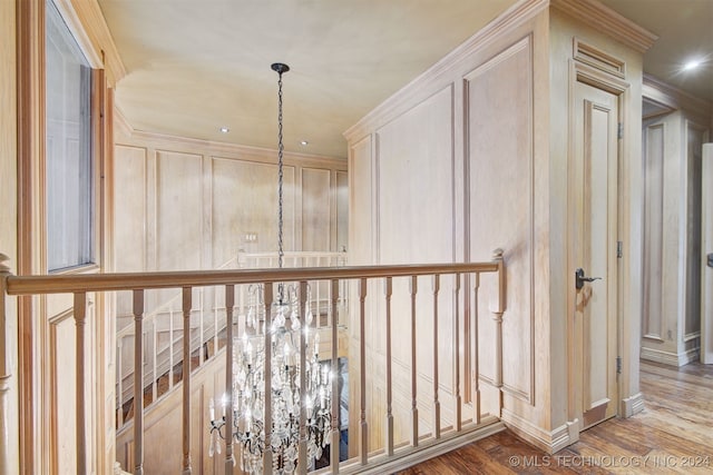 hall with hardwood / wood-style flooring and ornamental molding