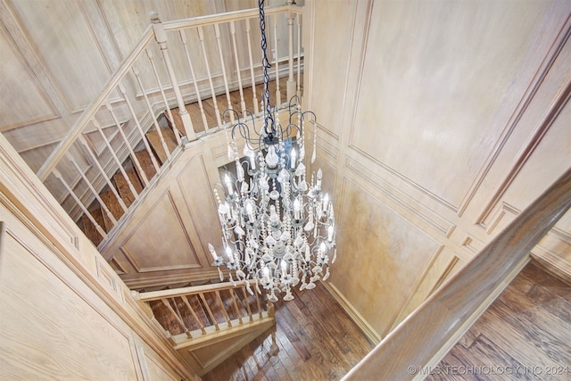 details featuring hardwood / wood-style flooring and an inviting chandelier