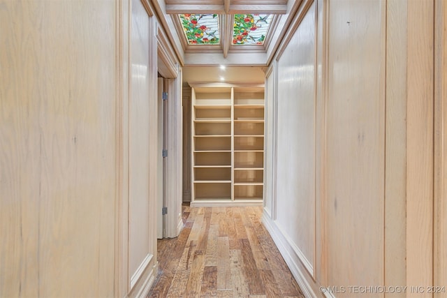 hall featuring built in features and wood-type flooring