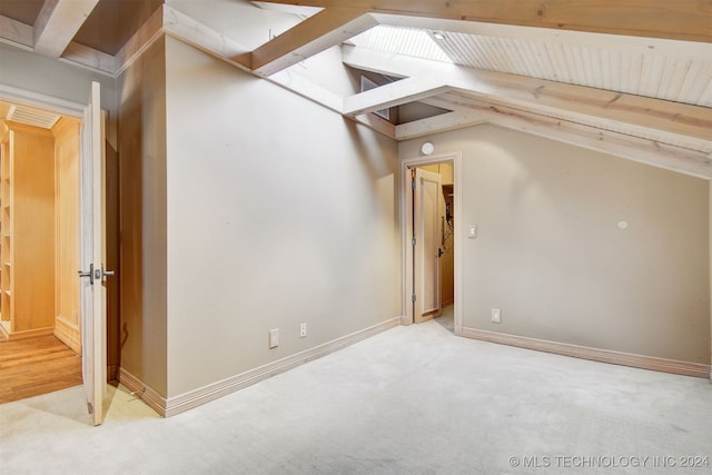 additional living space with vaulted ceiling with beams and carpet floors