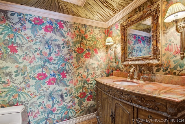 bathroom with vanity, toilet, and ornamental molding