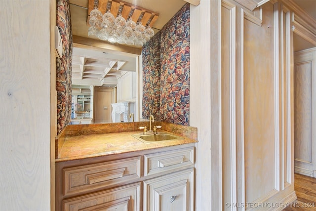 bathroom with beam ceiling, vanity, hardwood / wood-style flooring, and coffered ceiling