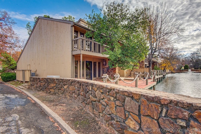 view of side of home with a balcony