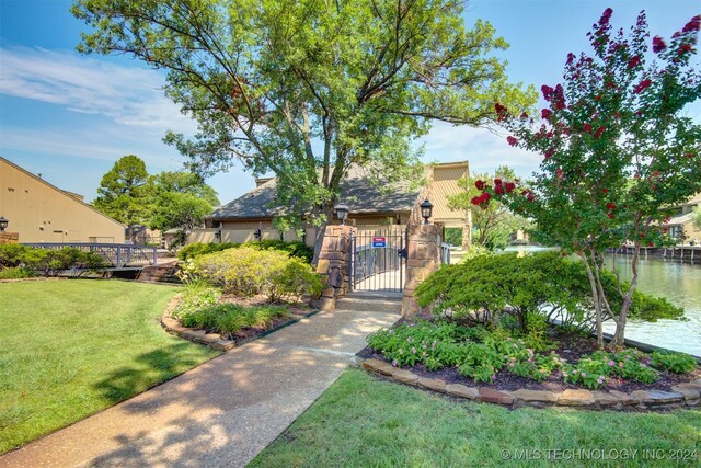 exterior space featuring a lawn and a water view