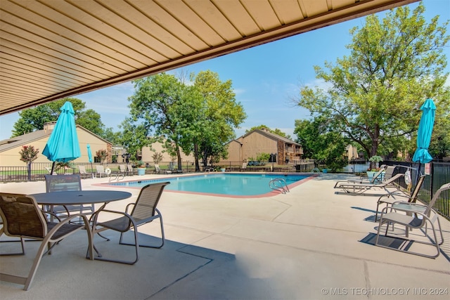 view of swimming pool featuring a patio area