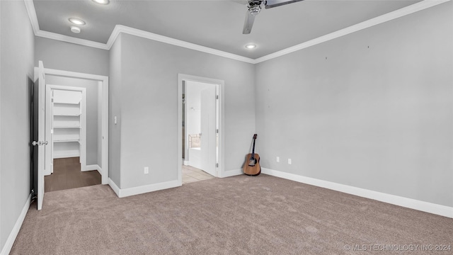 unfurnished bedroom featuring ceiling fan, crown molding, and light colored carpet