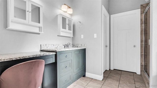 bathroom with tile patterned floors, vanity, and a shower with shower door