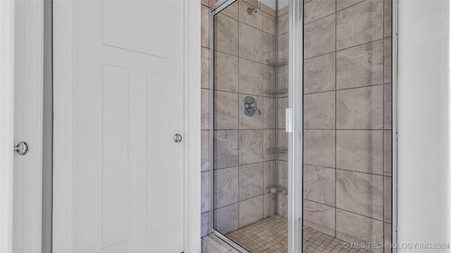 bathroom with a shower with door