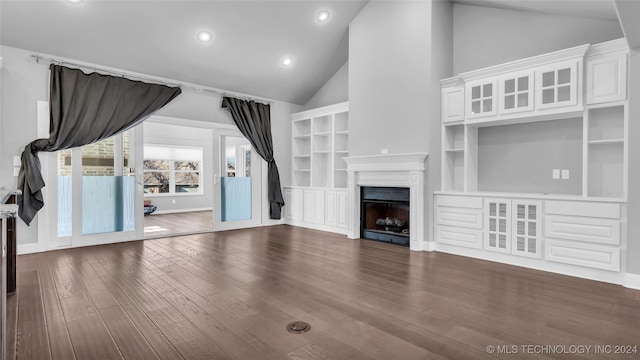 unfurnished living room featuring built in shelves, high vaulted ceiling, and dark wood-type flooring