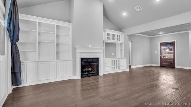 unfurnished living room featuring dark hardwood / wood-style floors, crown molding, and vaulted ceiling