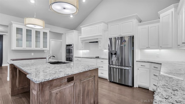 kitchen featuring white cabinets, sink, stainless steel appliances, and tasteful backsplash