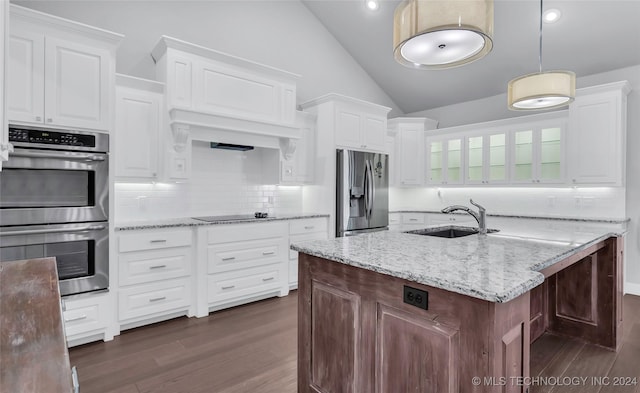 kitchen with sink, vaulted ceiling, appliances with stainless steel finishes, dark hardwood / wood-style flooring, and white cabinetry