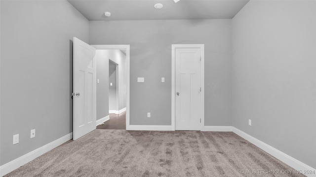 unfurnished room featuring light carpet