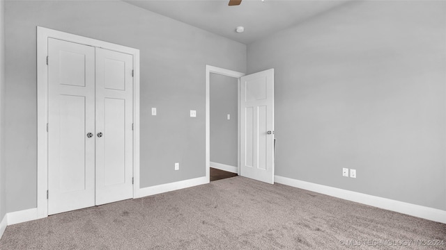 unfurnished bedroom featuring ceiling fan, carpet floors, and a closet