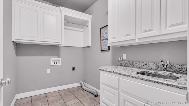 laundry room featuring cabinets, sink, washer hookup, light tile patterned floors, and hookup for an electric dryer