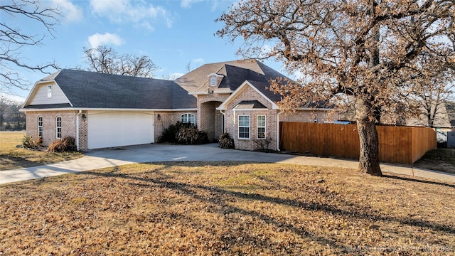 front of property featuring a front yard and a garage