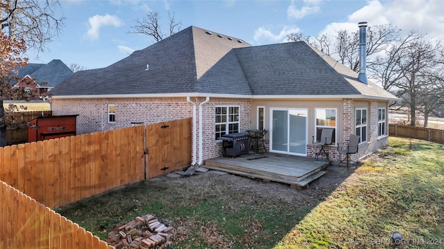 back of property featuring a yard and a deck