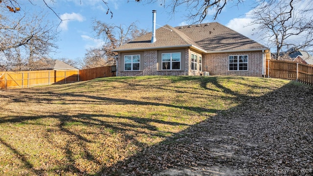 rear view of house with a yard