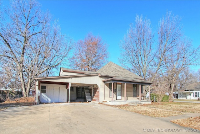 view of front of property with covered porch and a carport