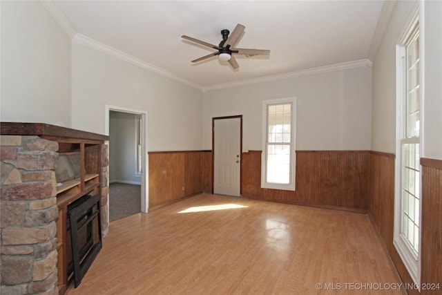 unfurnished living room with ceiling fan, ornamental molding, and light hardwood / wood-style flooring