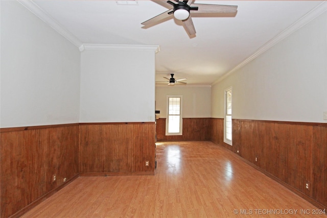 unfurnished room featuring ceiling fan, light hardwood / wood-style flooring, and ornamental molding