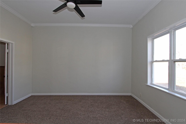 empty room featuring ceiling fan, plenty of natural light, dark carpet, and ornamental molding