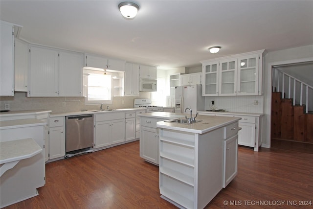 kitchen featuring white appliances, sink, a center island with sink, dark hardwood / wood-style floors, and white cabinetry