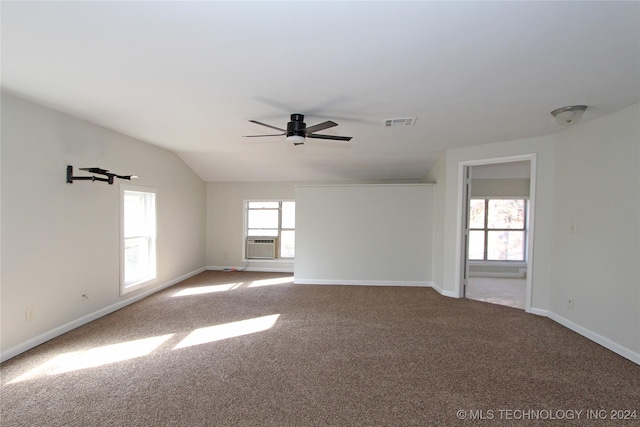 carpeted empty room featuring ceiling fan, cooling unit, and vaulted ceiling